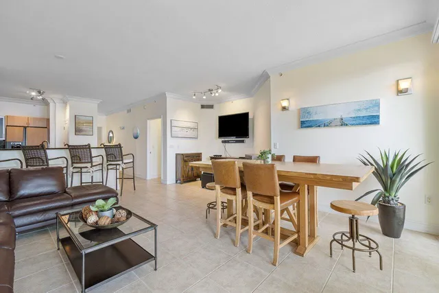 a living room with furniture a flat screen tv and a table