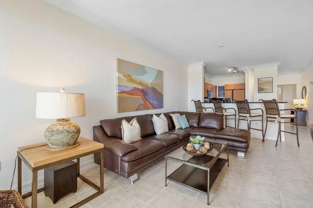 a living room with furniture and kitchen view