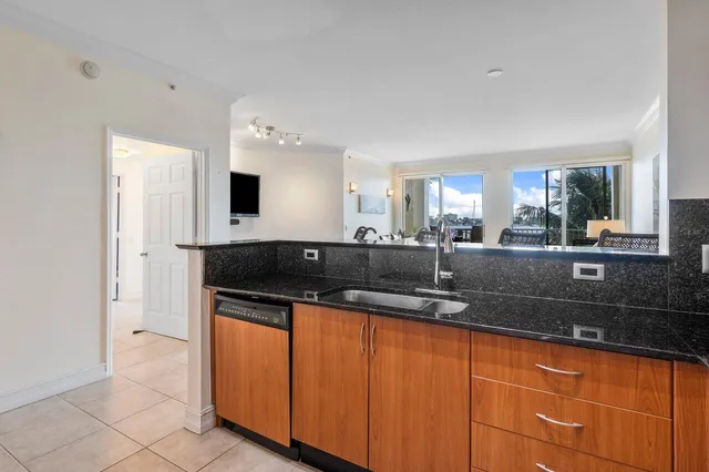a kitchen with granite countertop a sink and a cabinets