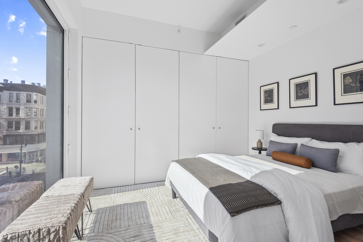 330 Grand Street, Unit 2B Manhattan, NY 10002 - Photo 3 of 16 a bedroom with a bed and a potted plant