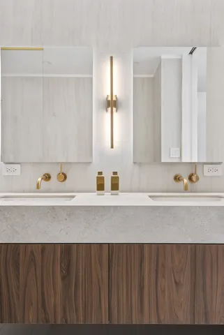 a bathroom with a double vanity sink mirror and shower