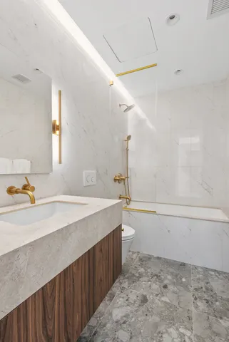 a bedroom with a bed a mirror and a window