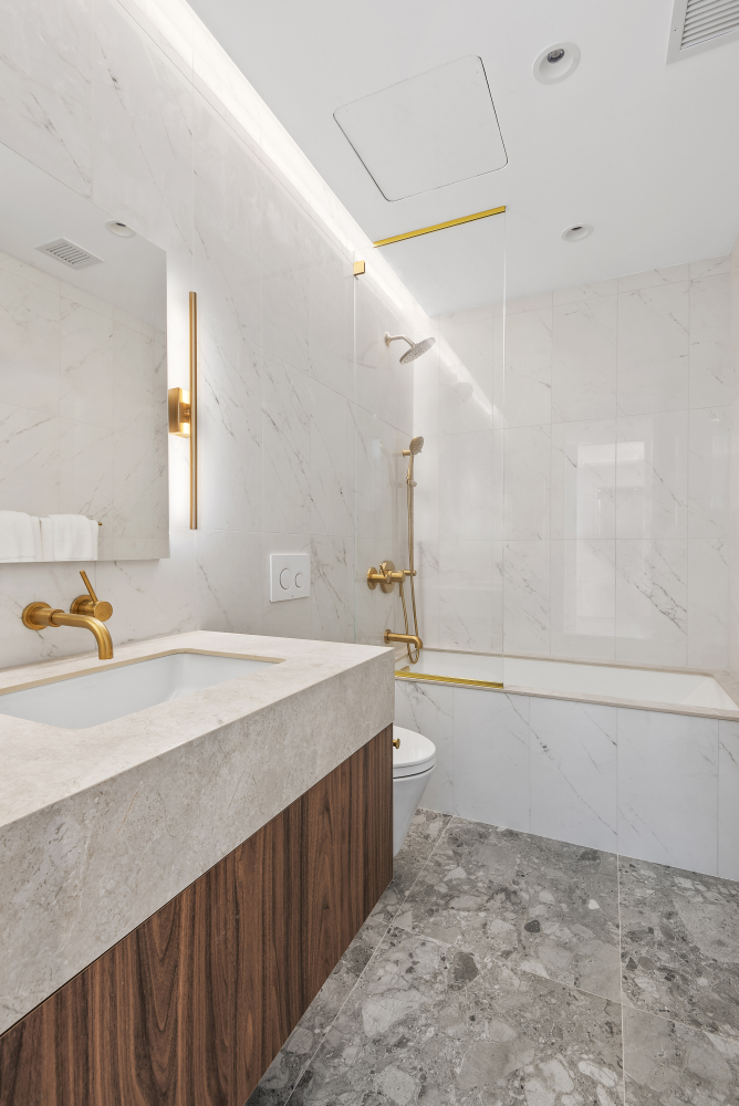 330 Grand Street, Unit 2B Manhattan, NY 10002 - Photo 7 of 16 a bathroom with a bathtub and a sink