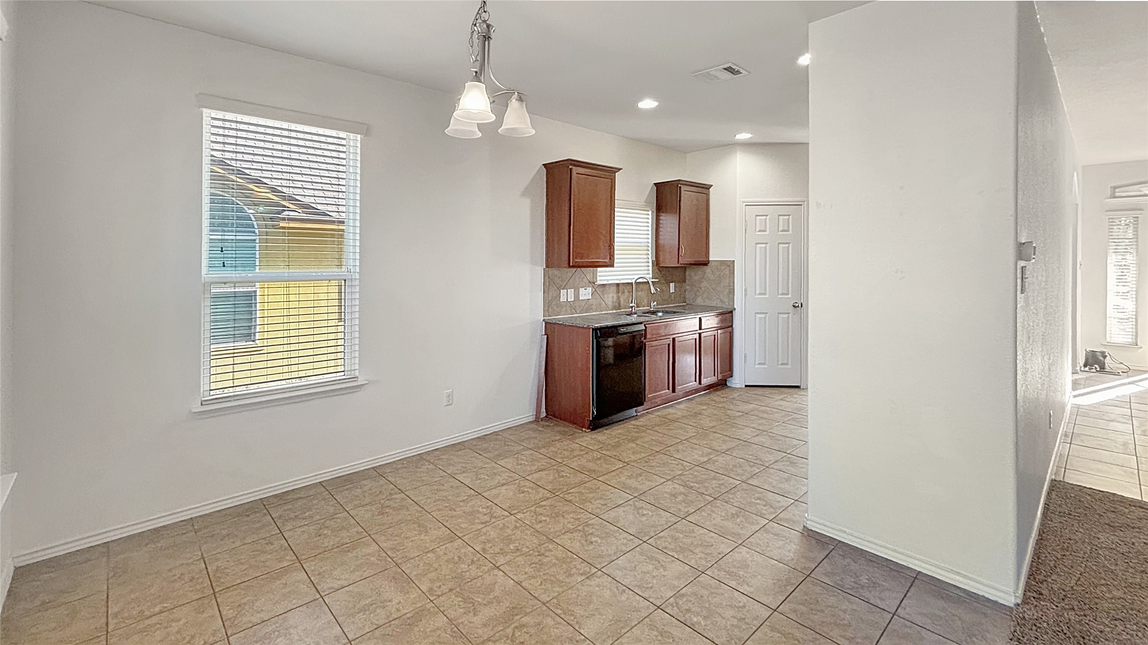 133 Langtry Lane Jarrell, TX 76537 - Photo 22 of 28 Breakfast area and kitchen with electric appliances. Just off the living room and kitchen with view of the front door