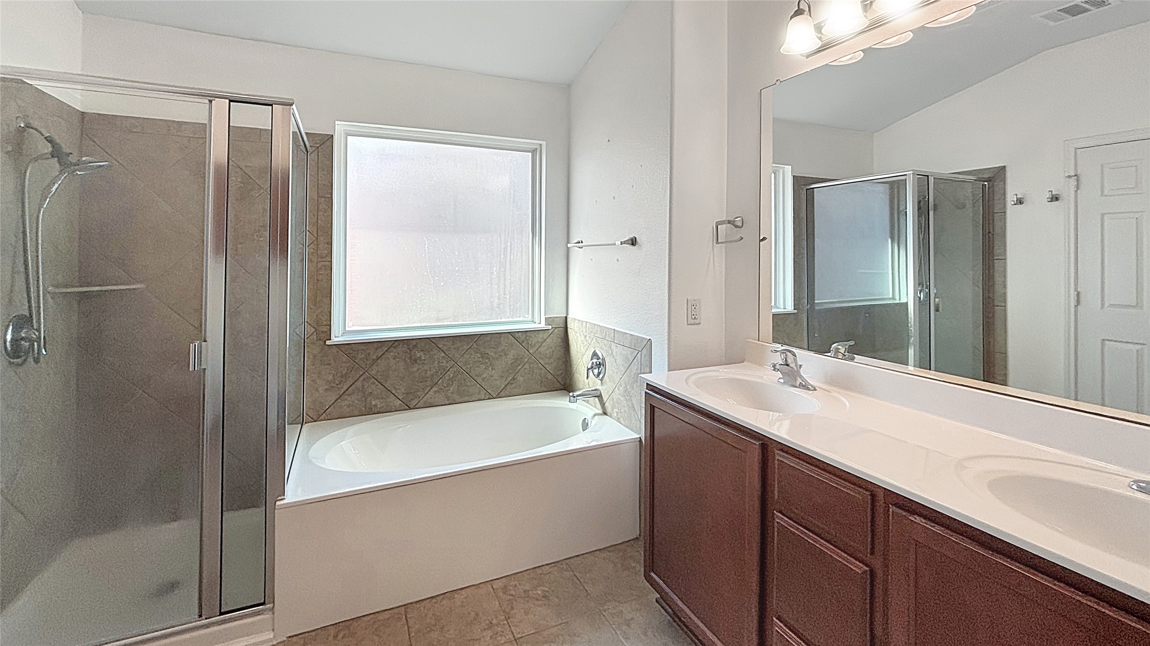 133 Langtry Lane Jarrell, TX 76537 - Photo 7 of 28 Primary bath with double sinks and separate garden tub and shower.