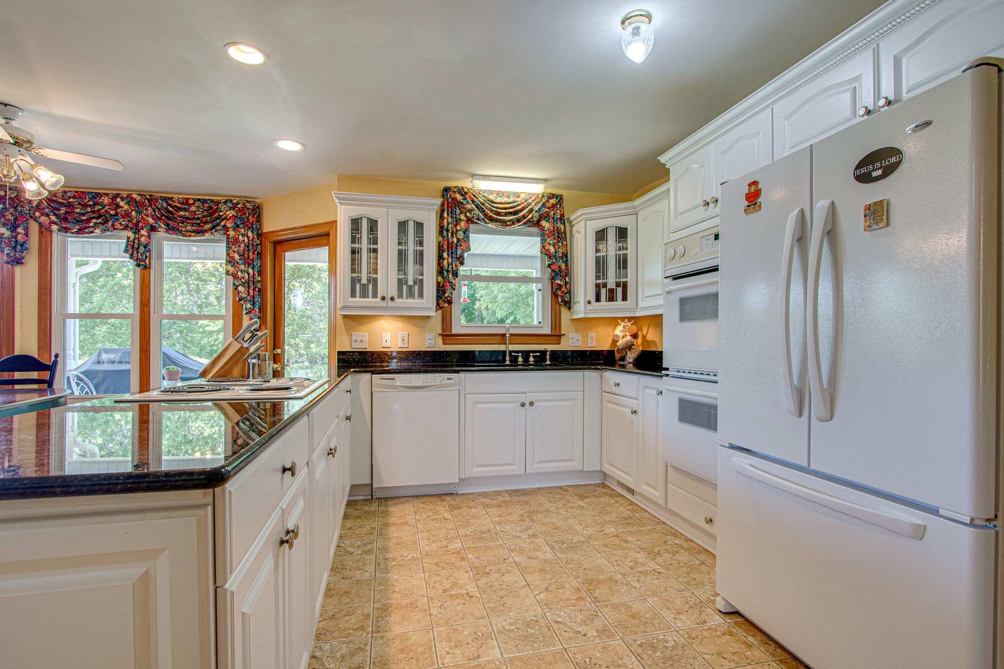 1802 Palmer Road Lebanon, TN 37090 - Photo 16 of 28 a kitchen with stainless steel appliances granite countertop a refrigerator and a stove