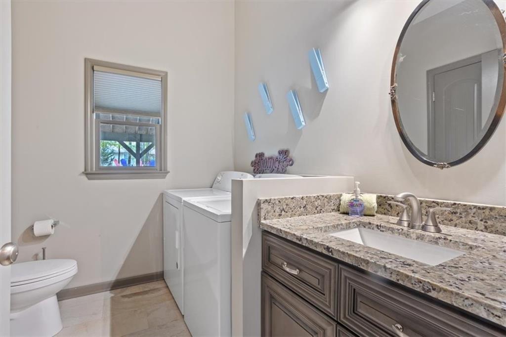 253 Zenith Trail Ellijay, GA 30540 - Photo 19 of 34 a bathroom with a granite countertop toilet sink and mirror