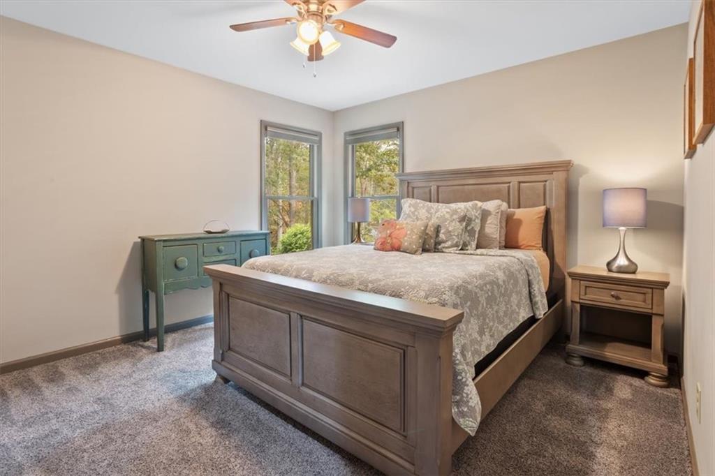 253 Zenith Trail Ellijay, GA 30540 - Photo 22 of 34 a bedroom with a bed and a chandelier