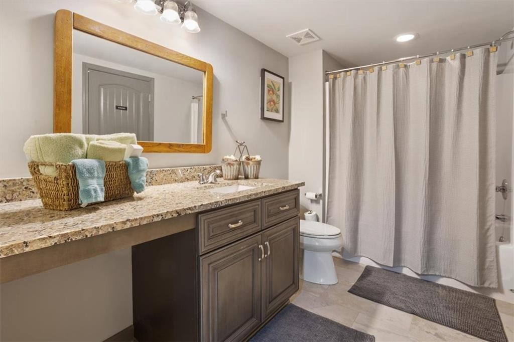 253 Zenith Trail Ellijay, GA 30540 - Photo 23 of 34 a bathroom with a granite countertop sink and a mirror