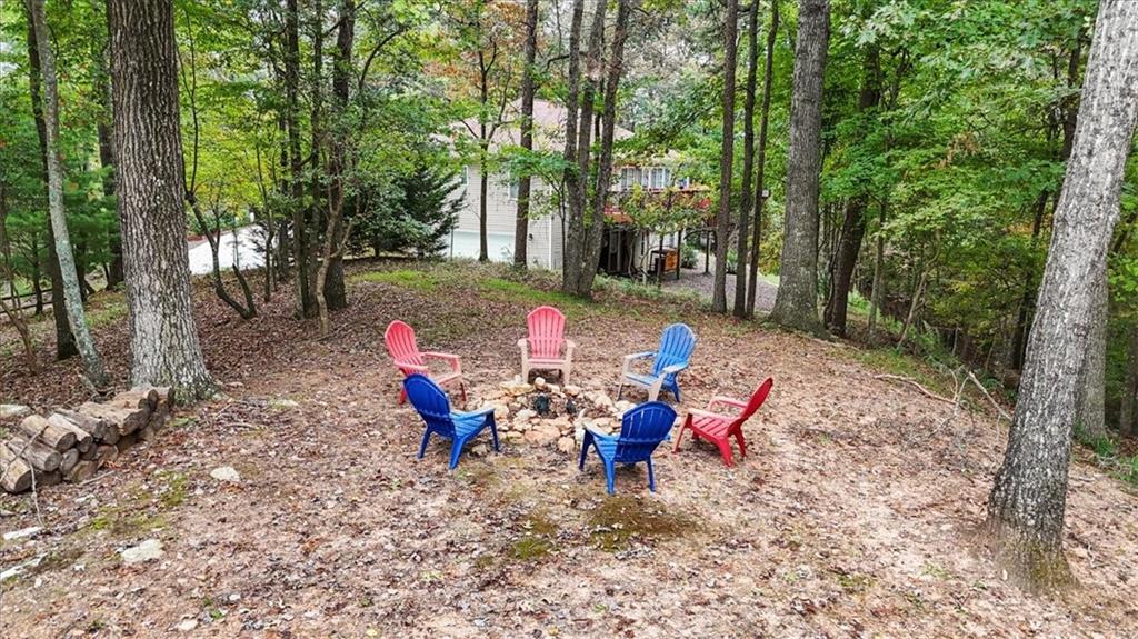 253 Zenith Trail Ellijay, GA 30540 - Photo 27 of 34 a view of a sitting area with fire pit in the forest