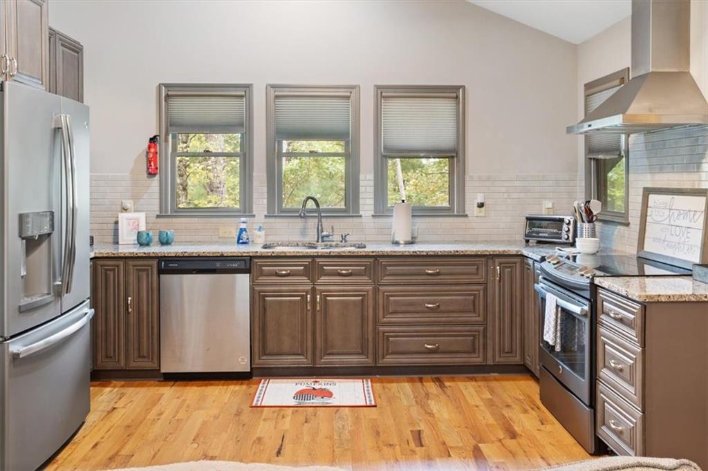 253 Zenith Trail Ellijay, GA 30540 - Photo 8 of 34 a kitchen with granite countertop a sink cabinets stainless steel appliances and a window