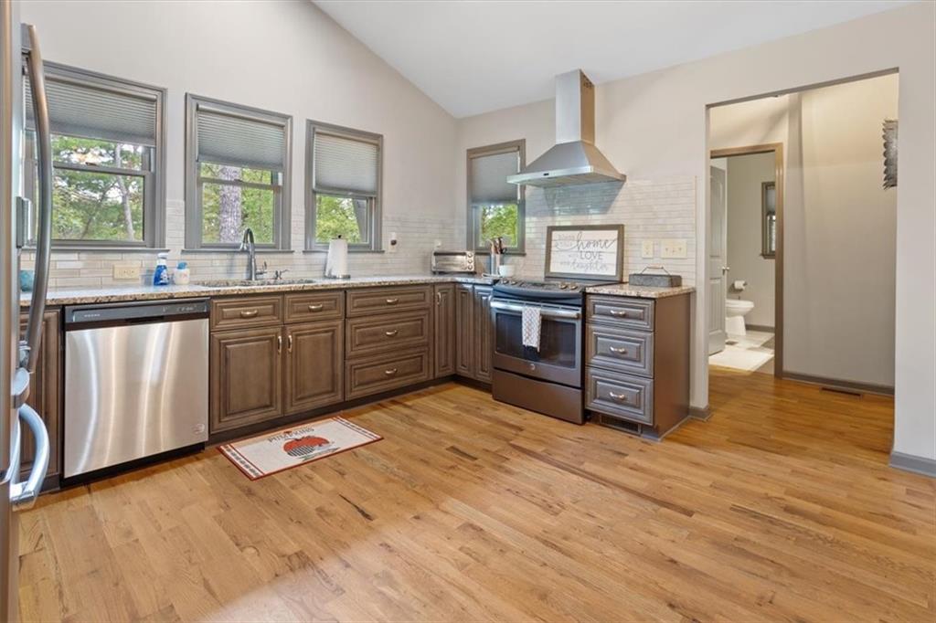 253 Zenith Trail Ellijay, GA 30540 - Photo 9 of 34 a kitchen with stainless steel appliances granite countertop a stove and a wooden floors
