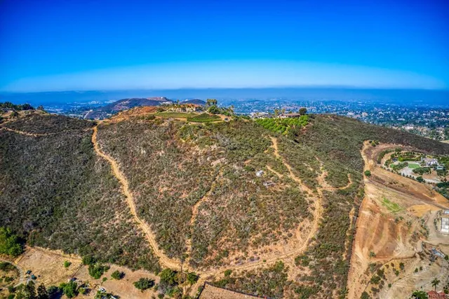 a view of a large building with mountains in the background