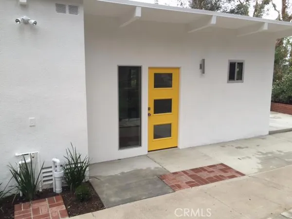 a view of backyard and front door