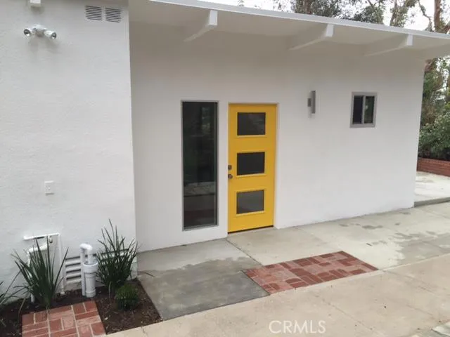 a view of backyard and front door
