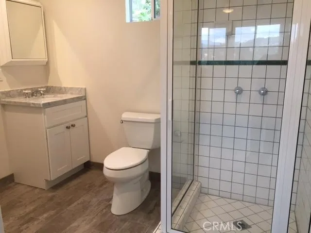 a bathroom with a toilet and a shower