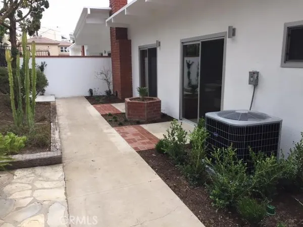 a view of a patio with table and chairs potted plants with wooden wall