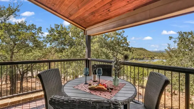 a view of a balcony with furniture and wooden floor