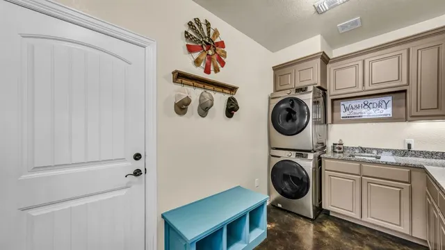 a utility room with sink dryer and washer