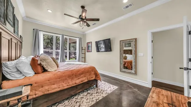 a bedroom with a large bed and a window