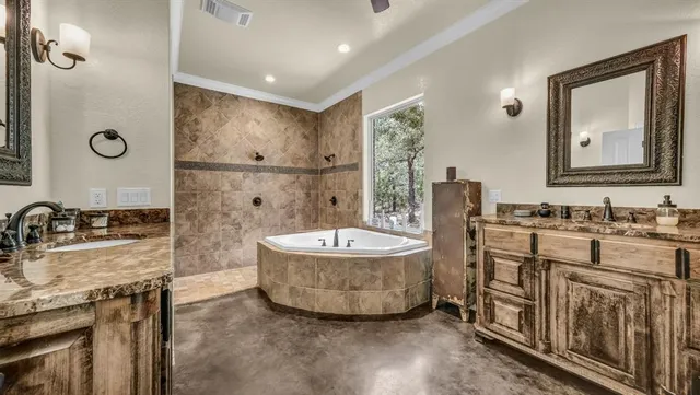 a bathroom with a granite countertop sink mirror vanity and bathtub