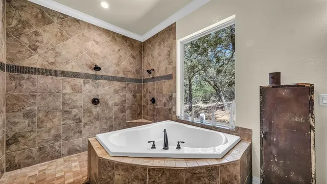 a bath tub sitting in a bathroom next to a window