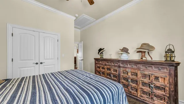 a bedroom with a bed and a chandelier