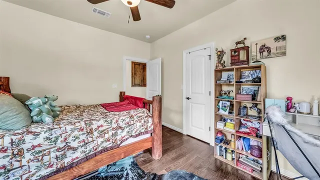 a bedroom with a bed and a book shelf