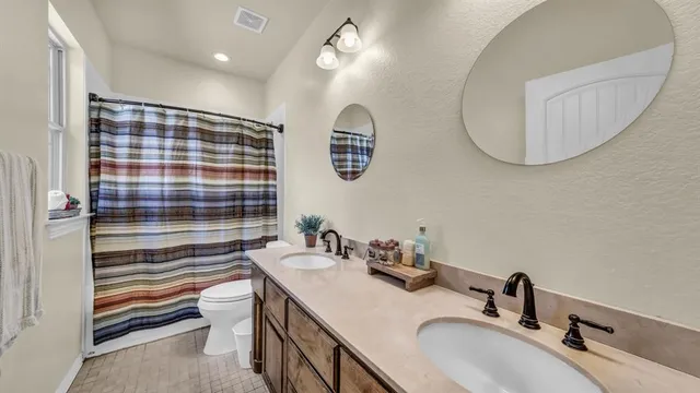 a bathroom with a sink double vanity and a mirror