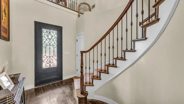 a view of entryway with wooden floor and stairs