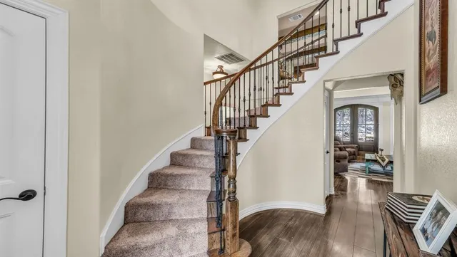 a view of entryway and hall with wooden floor