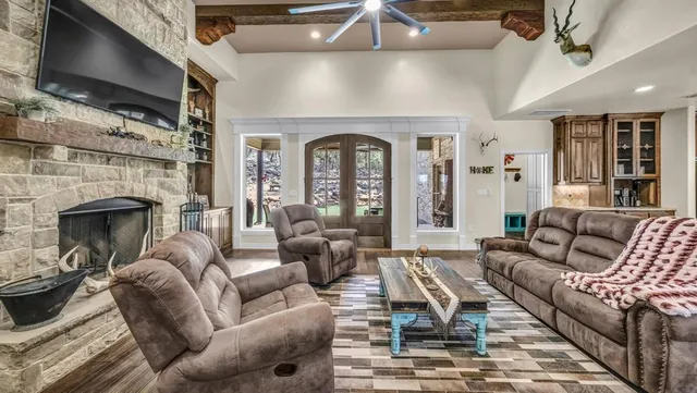 a living room with furniture a fireplace and a flat screen tv