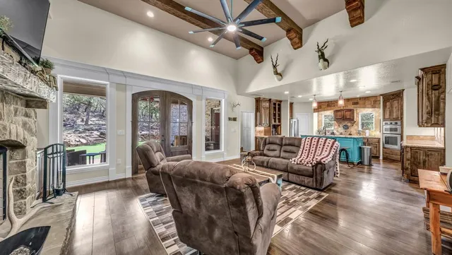 a large bedroom with furniture large windows and wooden floor