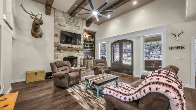 a living room with furniture fireplace and a flat screen tv