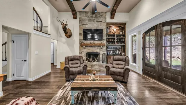 a living room with furniture fireplace and flat screen tv
