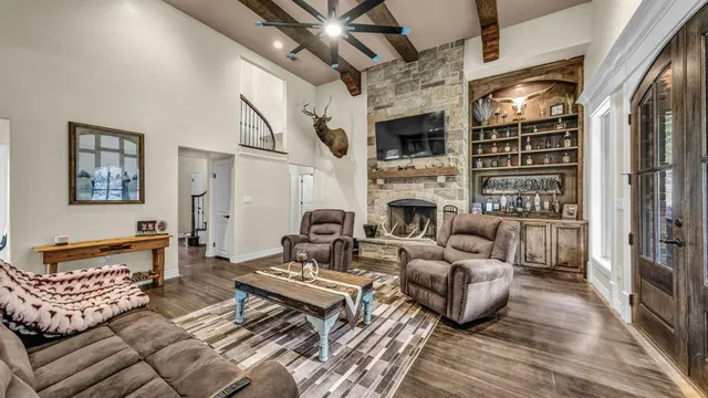 a living room with furniture fireplace and flat screen tv