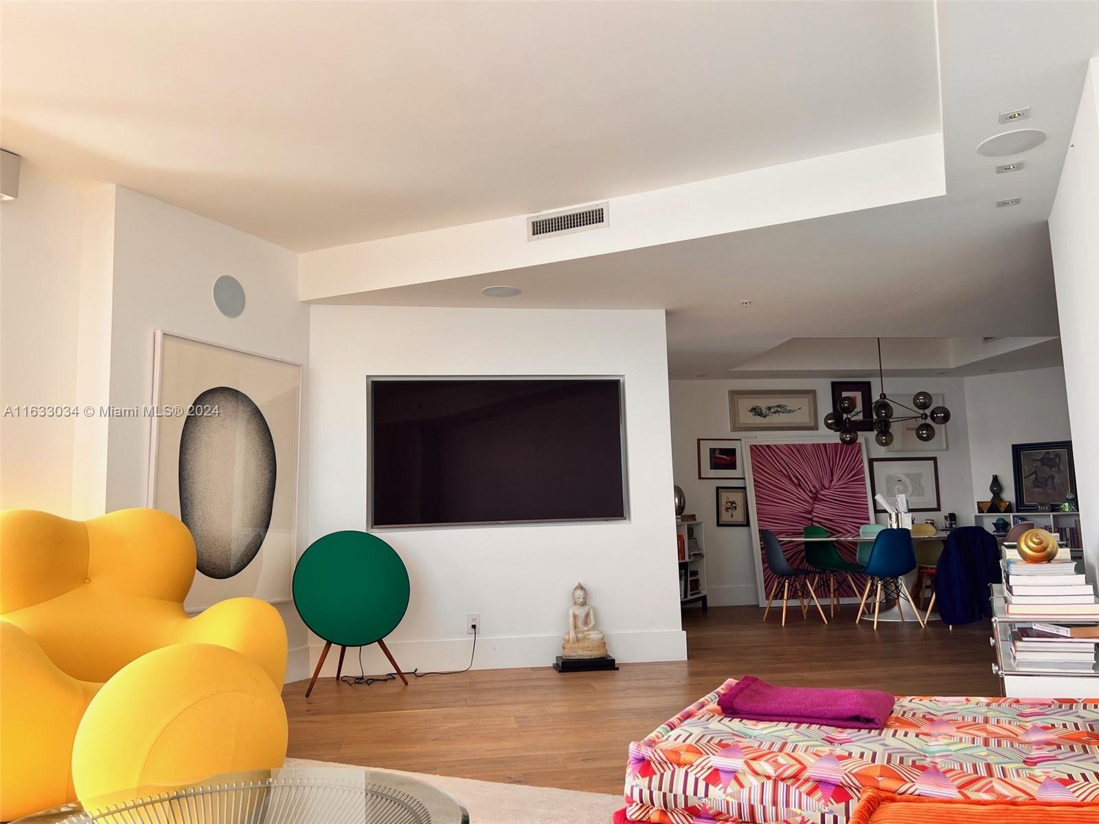 848 Brickell Key Drive, Unit 3701 Miami, FL 33131 - Photo 18 of 84 a living room with furniture a rug and a flat screen tv