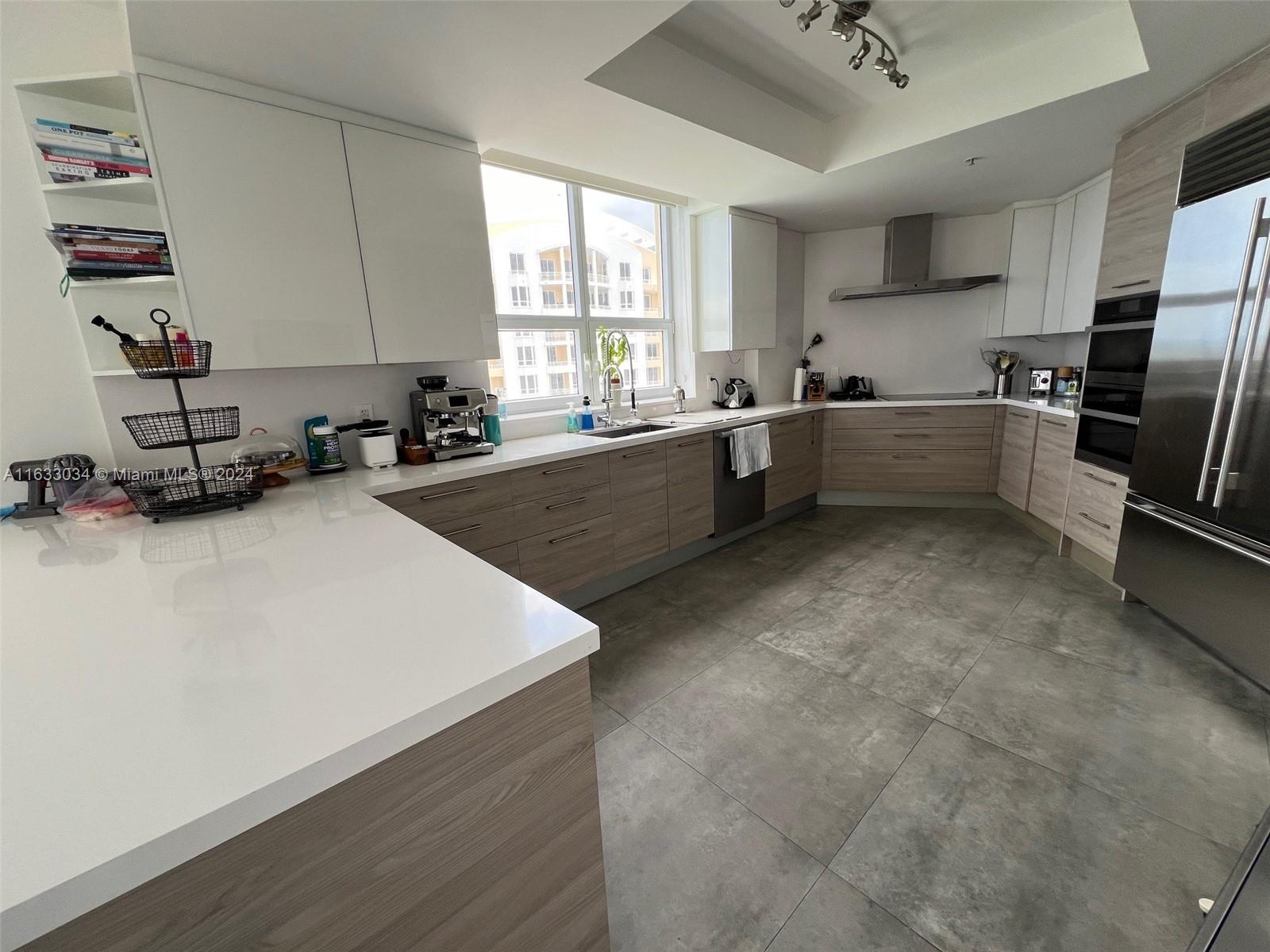 848 Brickell Key Drive, Unit 3701 Miami, FL 33131 - Photo 21 of 84 a kitchen with sink a window and stainless steel appliances