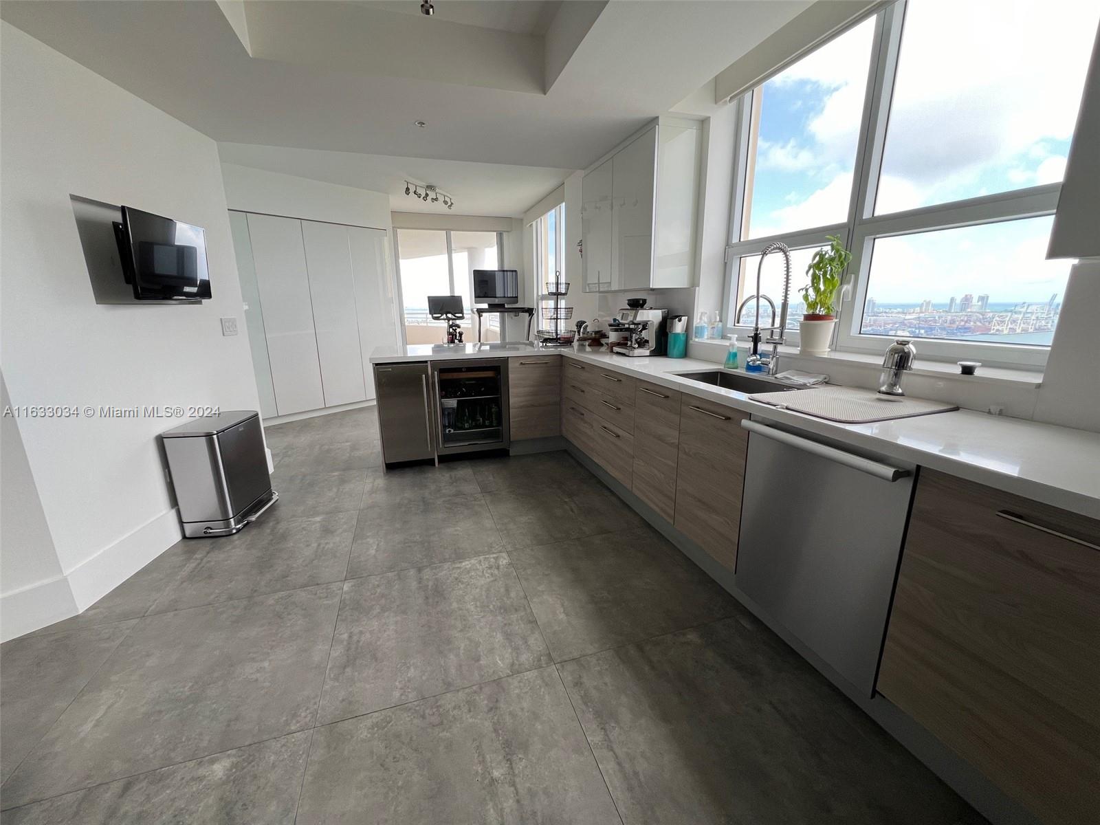 848 Brickell Key Drive, Unit 3701 Miami, FL 33131 - Photo 25 of 84 a kitchen with stainless steel appliances a sink a stove a microwave a refrigerator a window and a counter top space