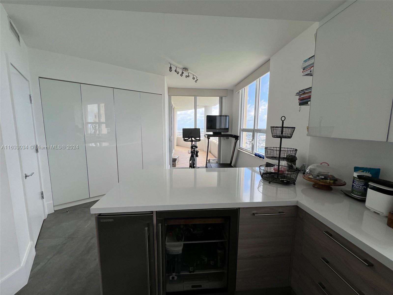 848 Brickell Key Drive, Unit 3701 Miami, FL 33131 - Photo 27 of 84 a kitchen with a refrigerator and a sink