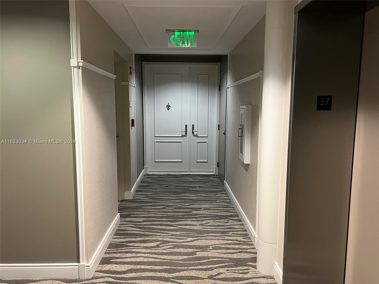 848 Brickell Key Drive, Unit 3701 Miami, FL 33131 - Photo 33 of 84 a view of a hallway with wooden floor and staircase