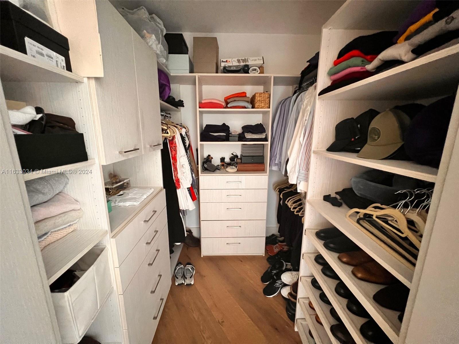 848 Brickell Key Drive, Unit 3701 Miami, FL 33131 - Photo 41 of 84 a view of walk in closet with clothes and shoes