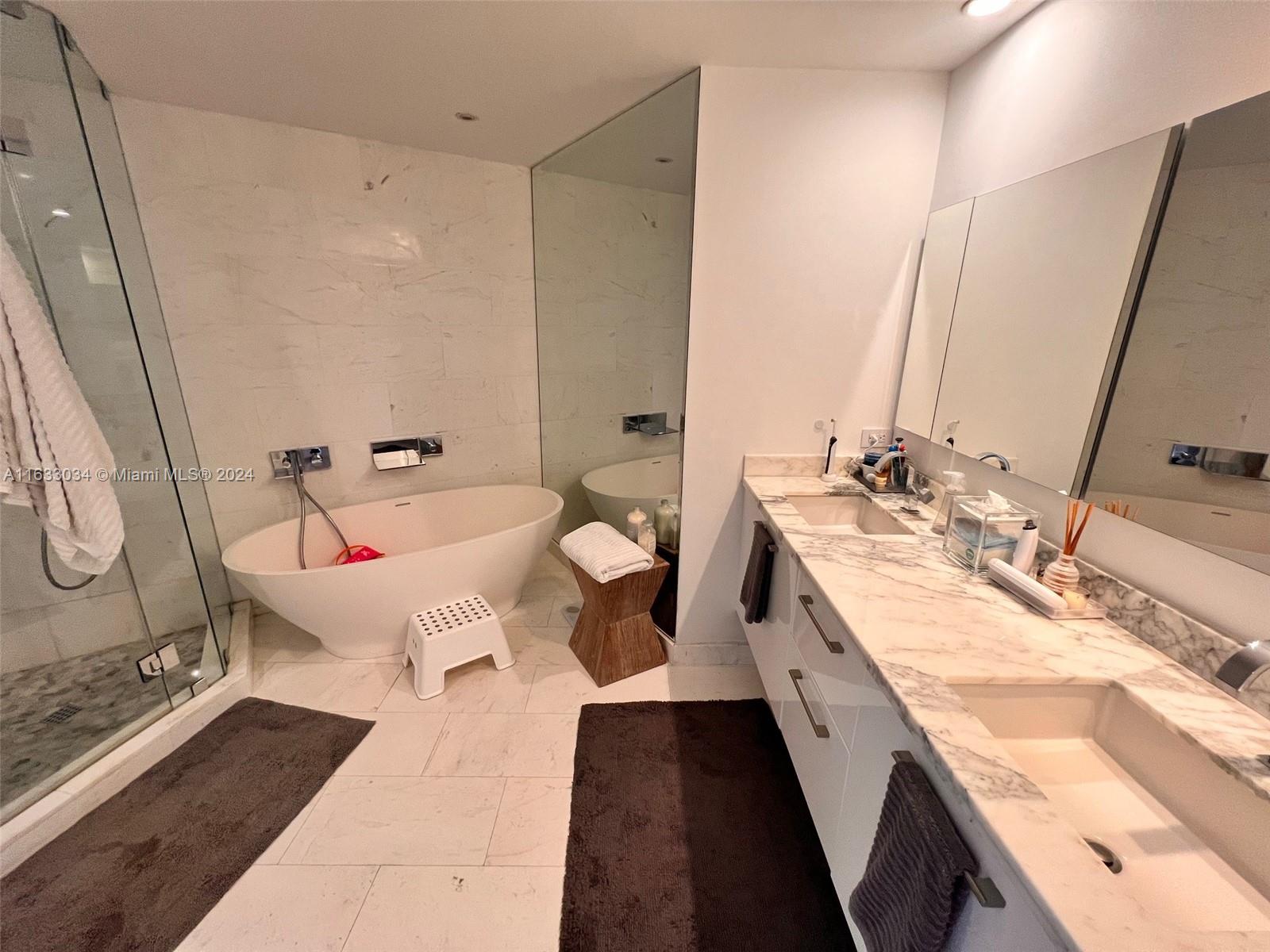 848 Brickell Key Drive, Unit 3701 Miami, FL 33131 - Photo 42 of 84 a spacious bathroom with double vanity sink and a mirror
