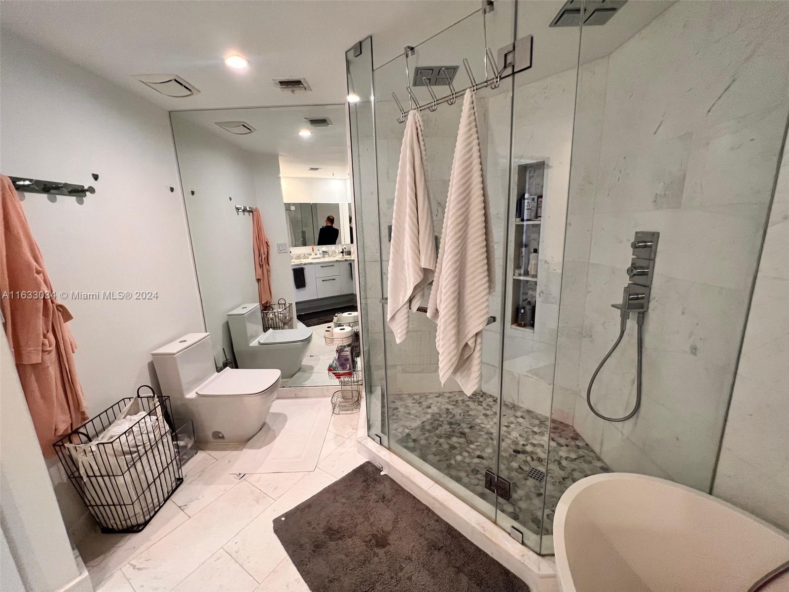 848 Brickell Key Drive, Unit 3701 Miami, FL 33131 - Photo 44 of 84 a bathroom with a toilet sink and shower