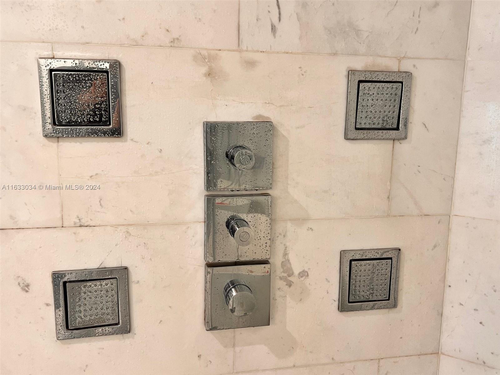 848 Brickell Key Drive, Unit 3701 Miami, FL 33131 - Photo 46 of 84 a bathroom with a shower and a window