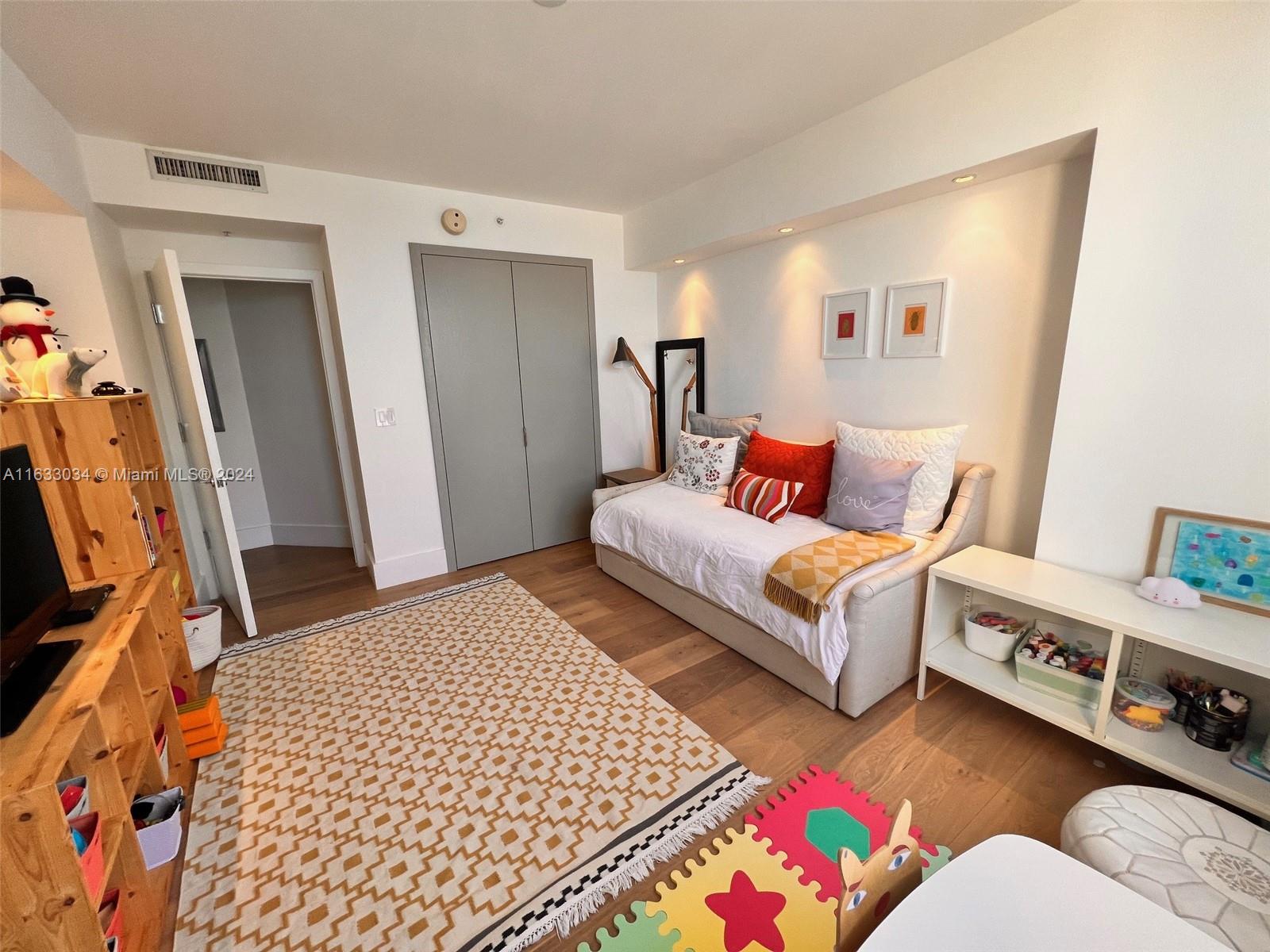 848 Brickell Key Drive, Unit 3701 Miami, FL 33131 - Photo 54 of 84 a bedroom with furniture and a couch