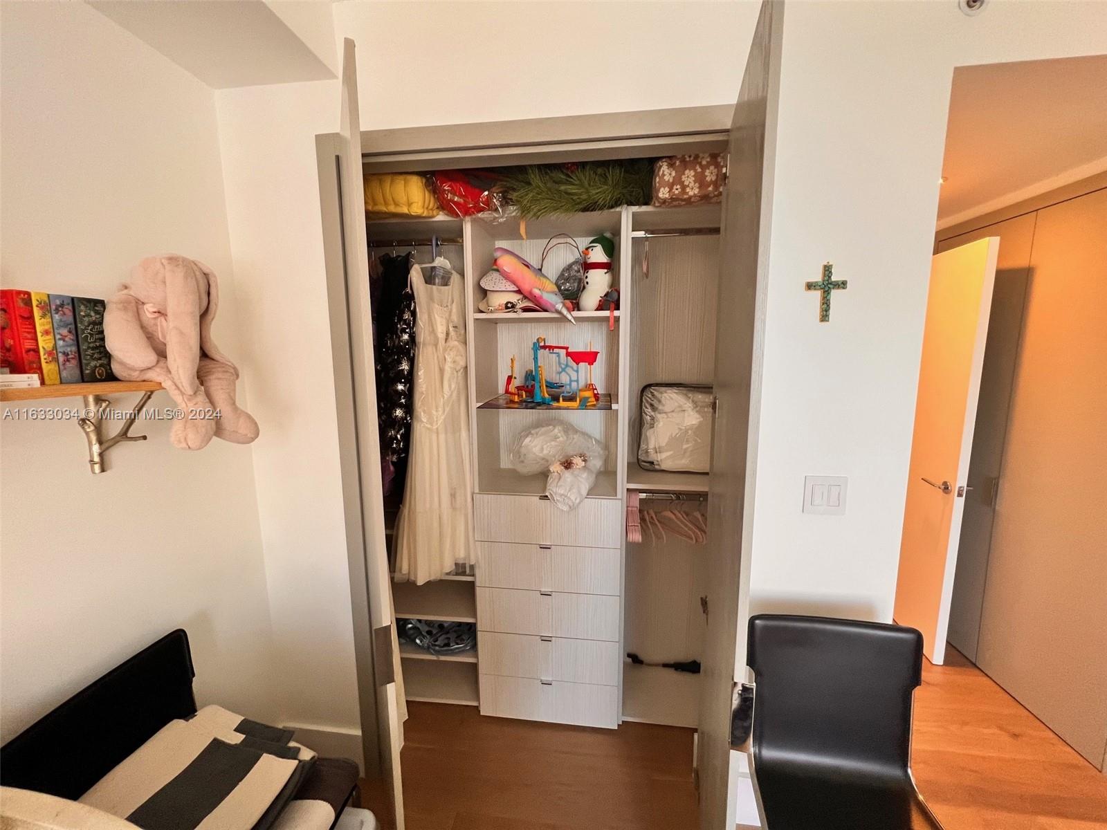 848 Brickell Key Drive, Unit 3701 Miami, FL 33131 - Photo 58 of 84 a view of walk in closet with clothes and shoes