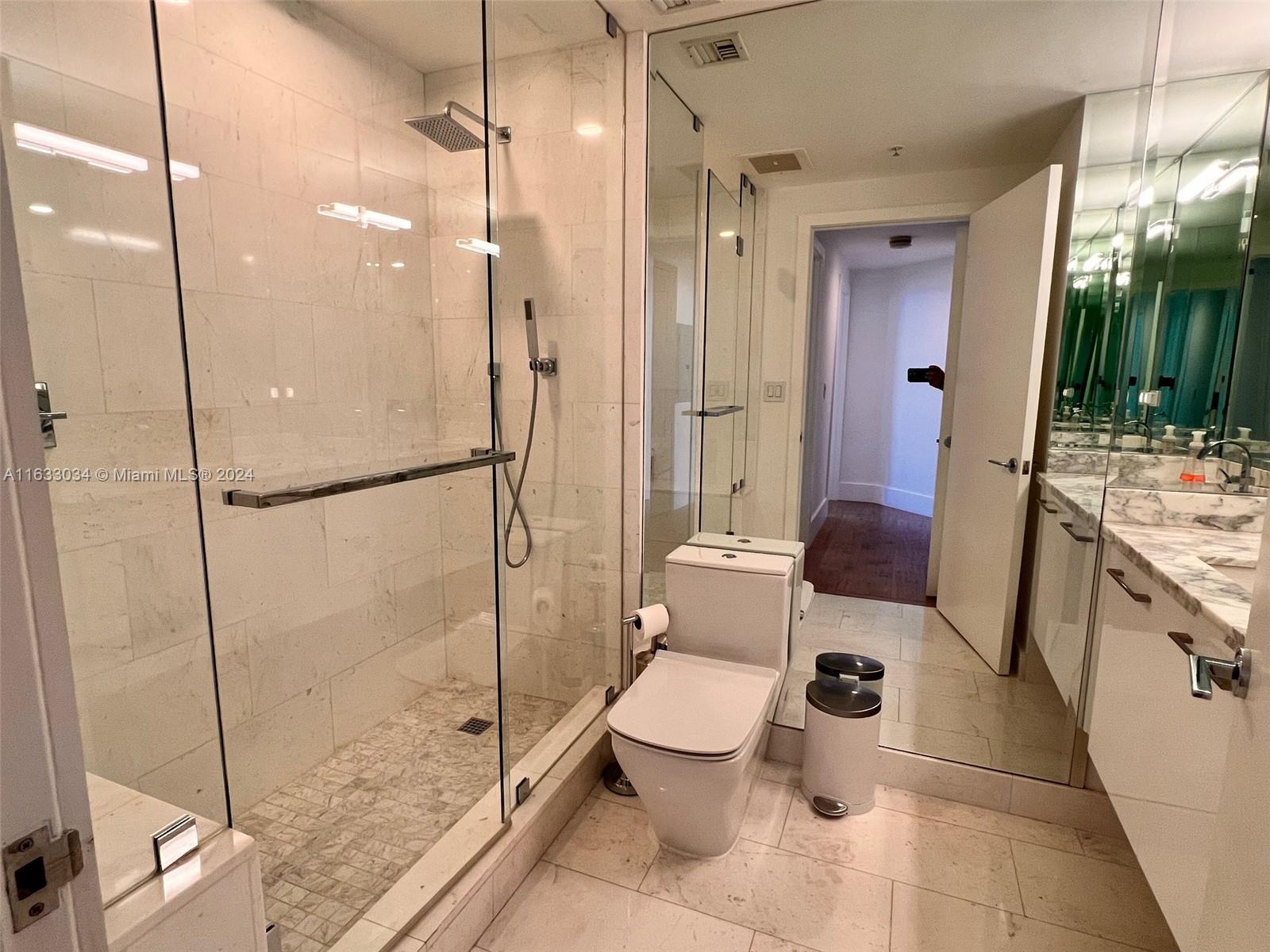 848 Brickell Key Drive, Unit 3701 Miami, FL 33131 - Photo 59 of 84 a bathroom with a toilet sink and a shower