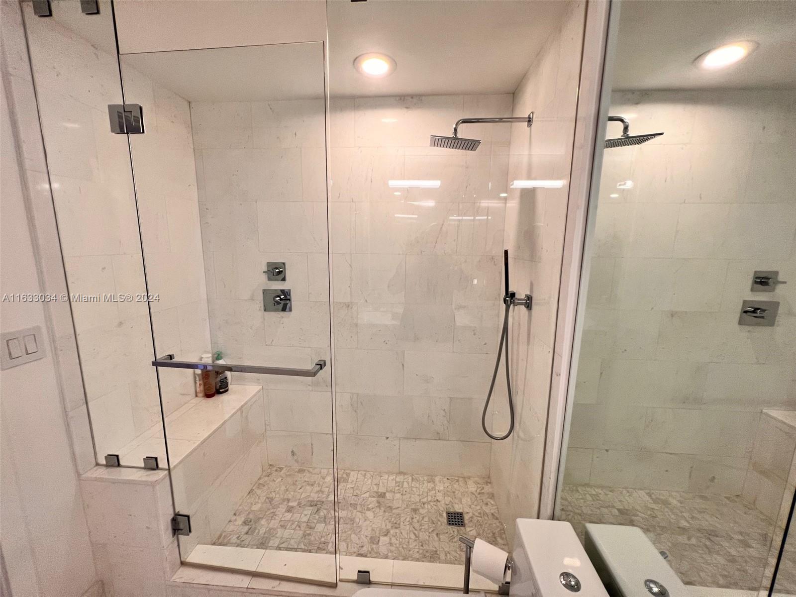 848 Brickell Key Drive, Unit 3701 Miami, FL 33131 - Photo 60 of 84 a bathroom with a glass shower door