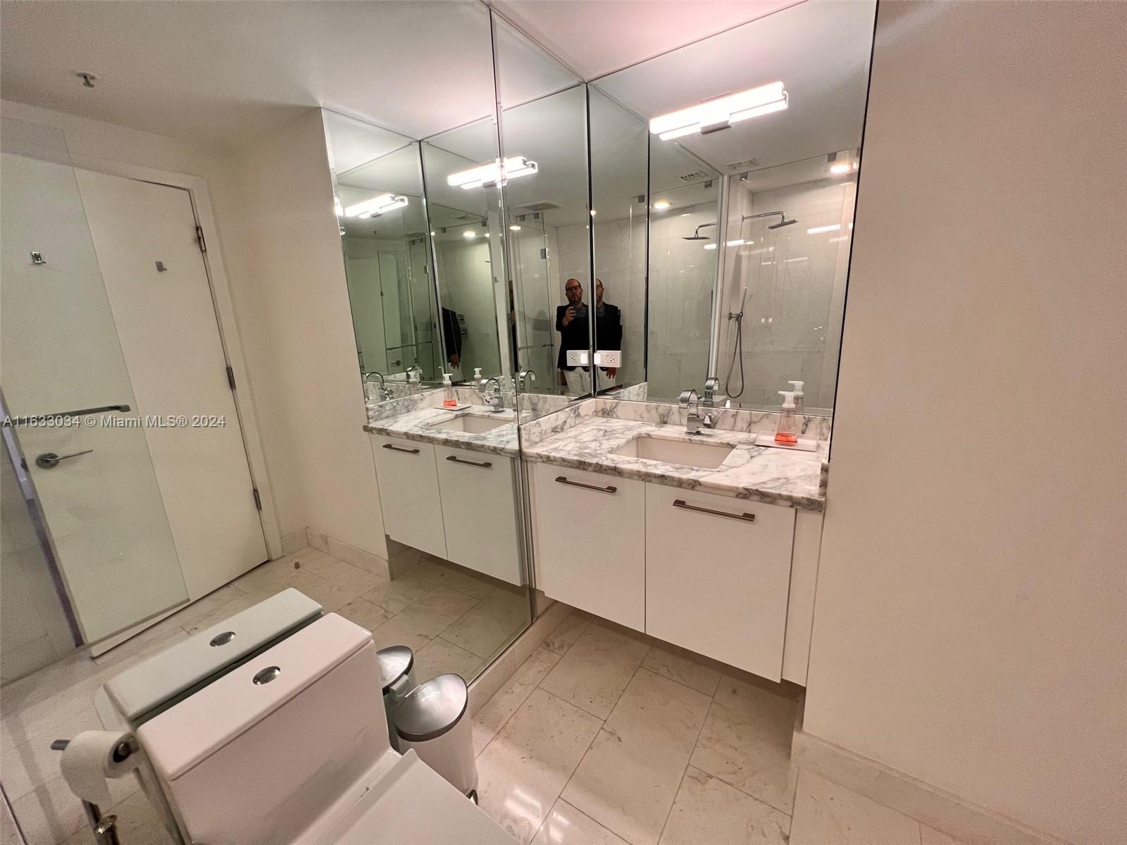 848 Brickell Key Drive, Unit 3701 Miami, FL 33131 - Photo 61 of 84 a bathroom with a sink vanity and mirror